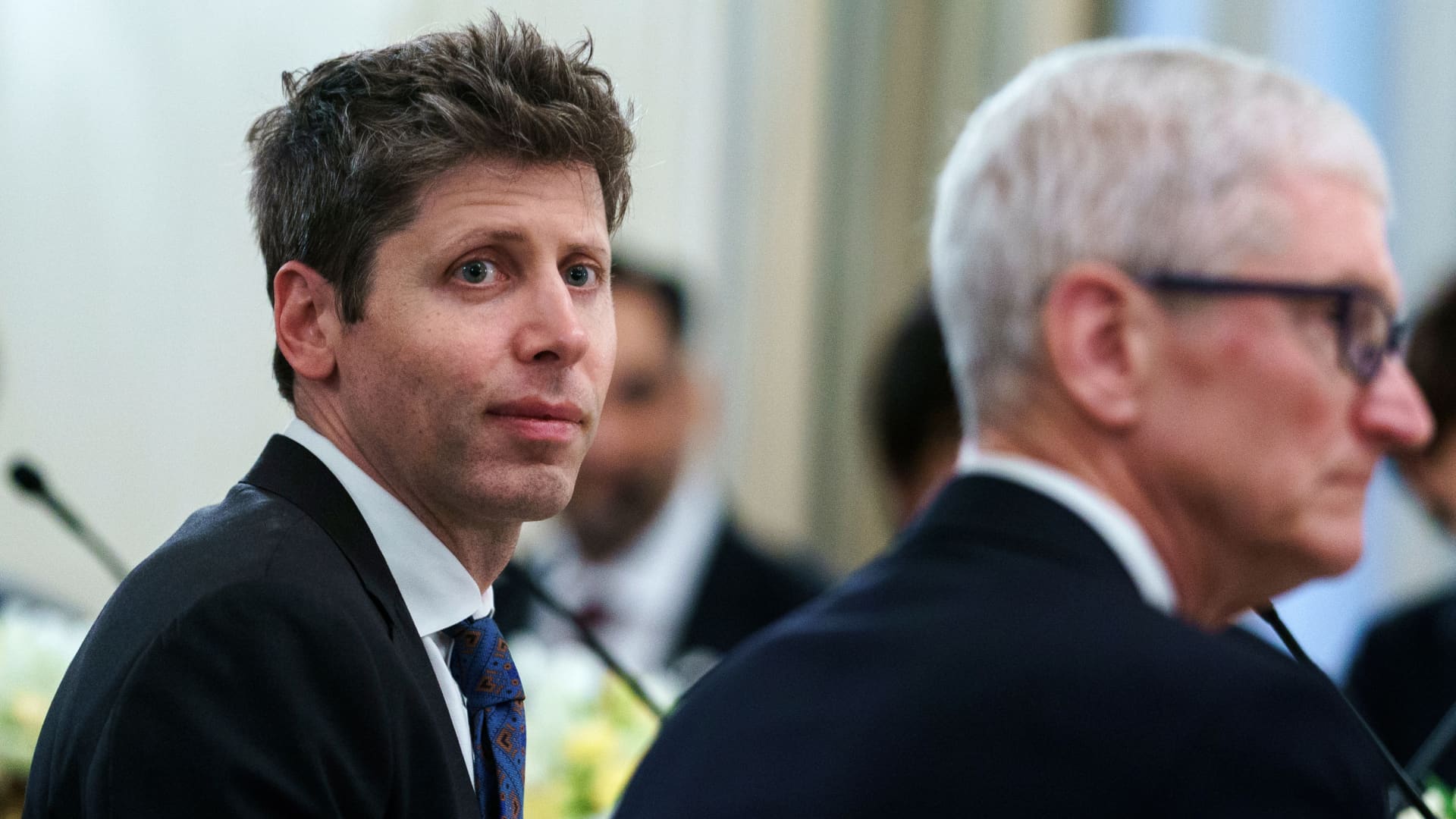 Tim Cook 与 Sam Altman 在 2025 年白宫科技领袖晚宴上同席而坐。两年后，两家公司从合作伙伴变成了法庭对手。