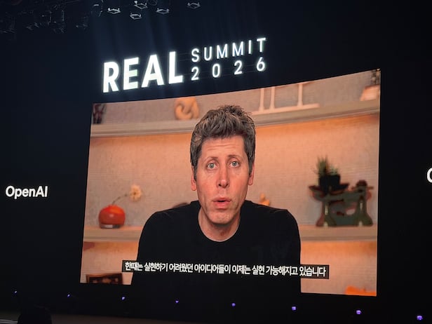 Sam Altman 在 Real Summit 2026 上以视频致辞，屏幕下方配有韩文字幕