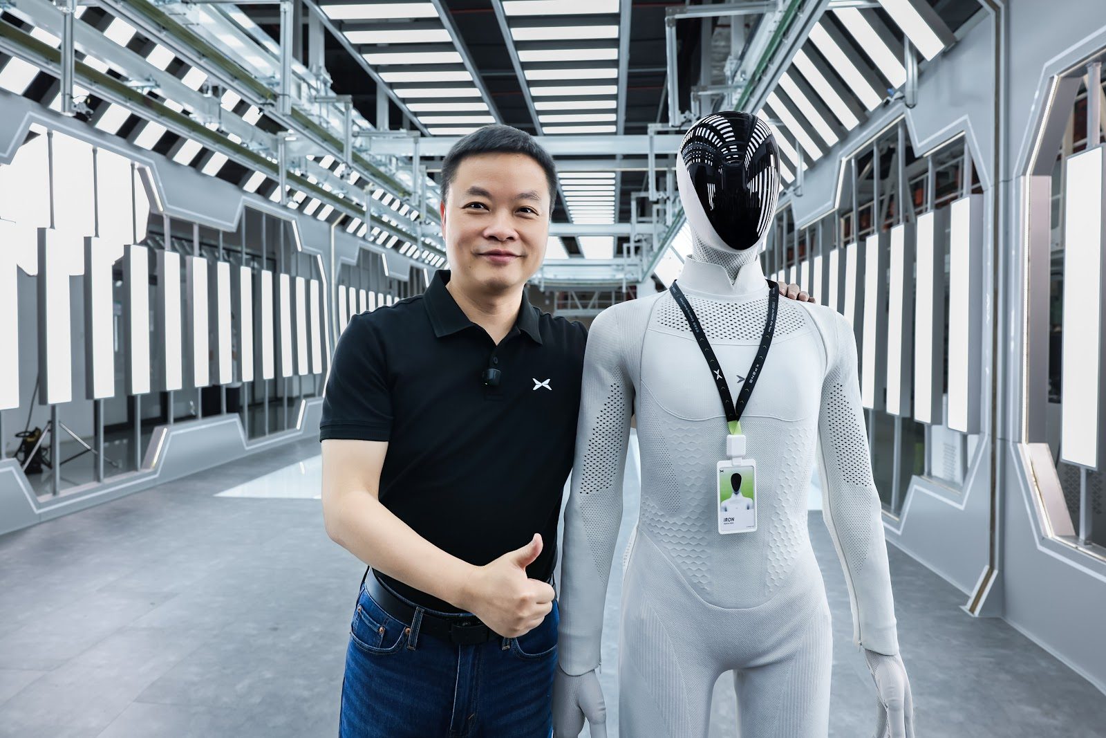 小鹏董事长兼 CEO 何小鹏与胸前别着工牌的 IRON 合影（图源：XPeng）